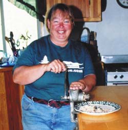 Author grinding shelled acorns in a hand grinder