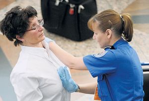 A passenger is searched at Denver International Airport