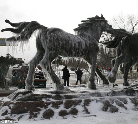 A statue in Ciudad Juarez, northern Mexico, is covered in ice as a result of the snow storm which swept in from the Arctic