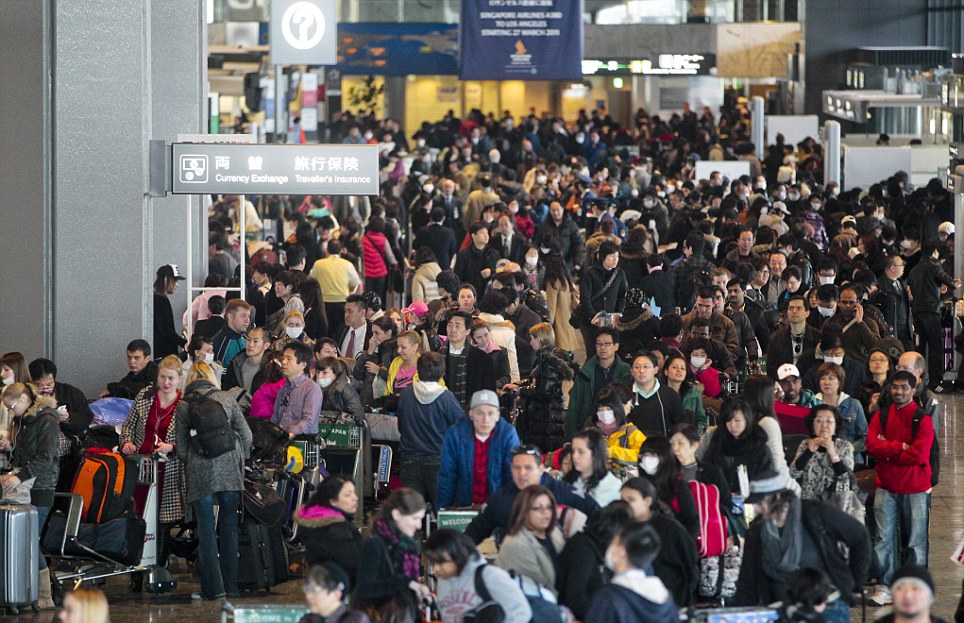 What a contrast: While the streets of Tokyo are empty, the city's airports are packed with residents hoping to get away