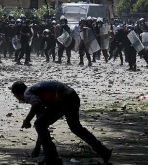 A protester throws stones at police during clashes going on for a third straight day, Thursday in Cairo, September 13, 2012. (Photo: Tara Todras-Whitehill / The New York Times) 