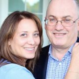 Stevie laughing with wife Alex at the SEC