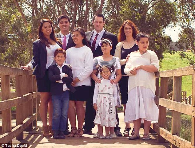 Tasha David (back right) tells how she chose to not vaccinate her two youngest children Sasa, eight (front left), and Chiante, five (front middle) after her first SIX (back row L-R: Asante, 16, Jourdahn, 25, middle row L-R: Deveraux, 20, Sahara, 14, Acacia, 10, Armaan, 12) suffered health problems