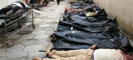 Bodies are laid out in Yarmouk hospital's yard in Baghdad, Iraq, 01/14/07. (photo: Khalid Mohammed/AP)