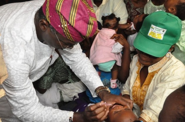 Governor Babatunde Fashola of Lagos immunising a child. Courtesy: Toluwa Olusegun Governor Babatunde Fashola of Lagos immunising a child. Courtesy: Toluwa Olusegun