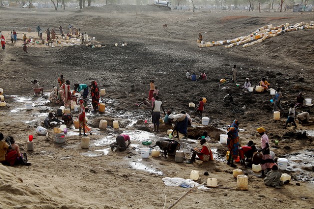 Refugees dig for water in a dried up watering hole in Jamam camp, in South Sudan's Upper Nile state. Credit: Jared Ferrie/IPS