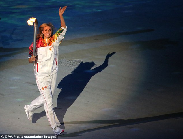 Sharapova carries the Olympic torch during the opening ceremony in  Sochi