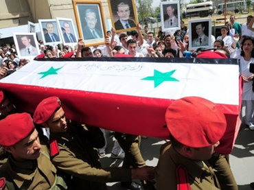 A photo released by the Syrian Arab news Agency (SANA) on April 27, 2011, shows one of 6 coffins of a killed member of either the army or security forces being taken from the October Military hospital in Damascus to their towns and villages for burial, following several days of unrest (AFP Photo)